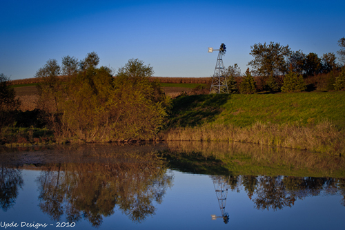 Windmill by a pond