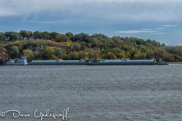 A barge passes through the railroad bridge