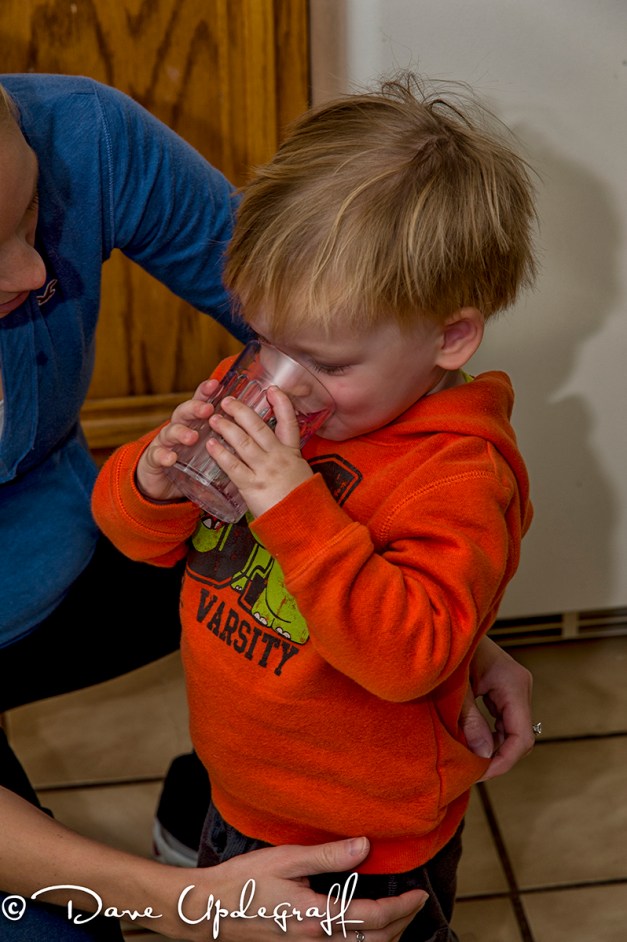 Josh drinks from a glass
