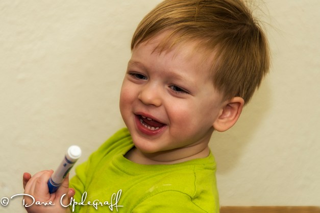 Joshua plays with markers